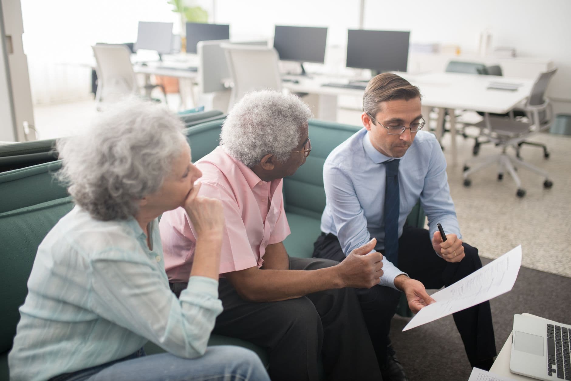A business professional consulting clients across a desk