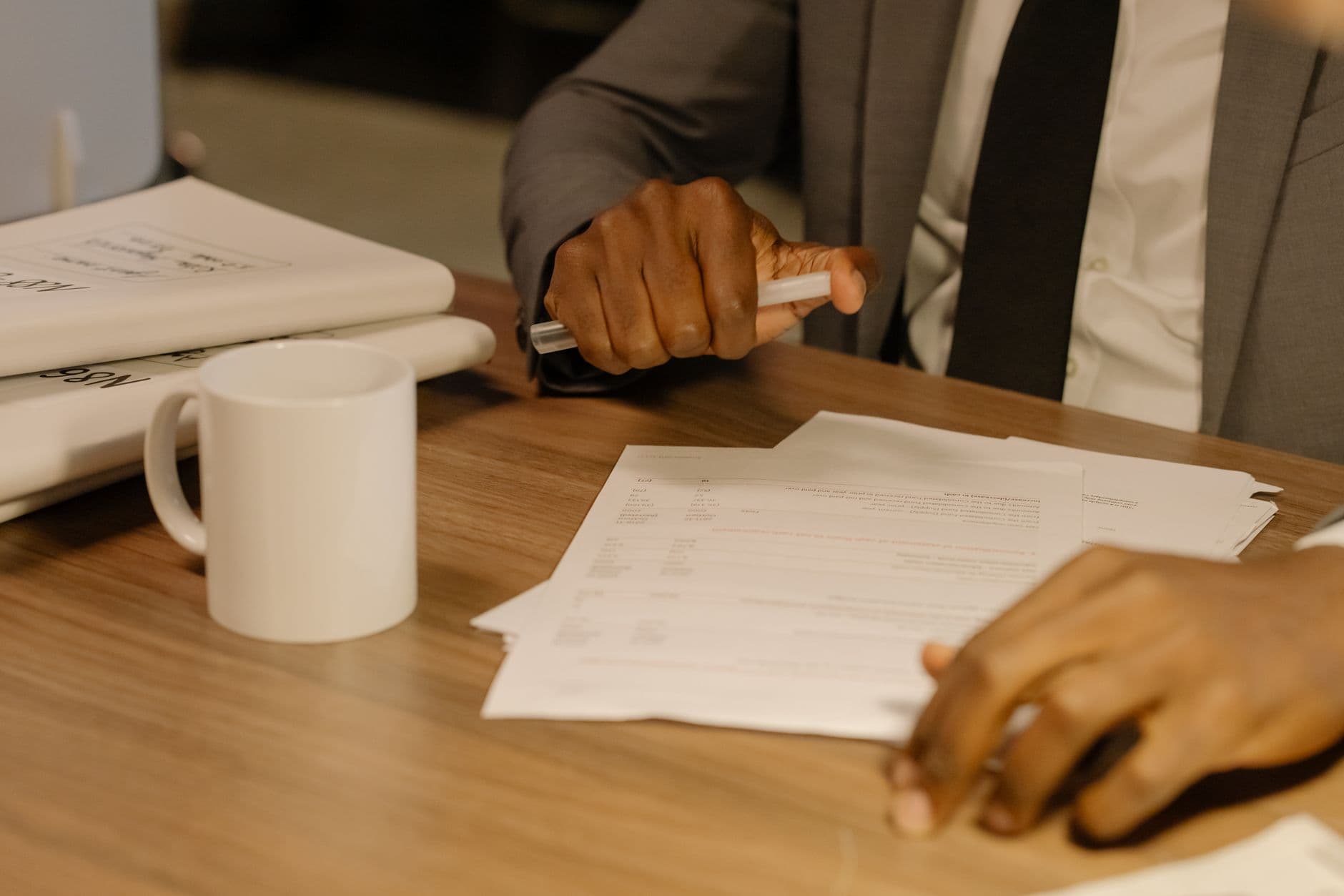 HR leader reviewing a compensation plan and org chart at a planning desk