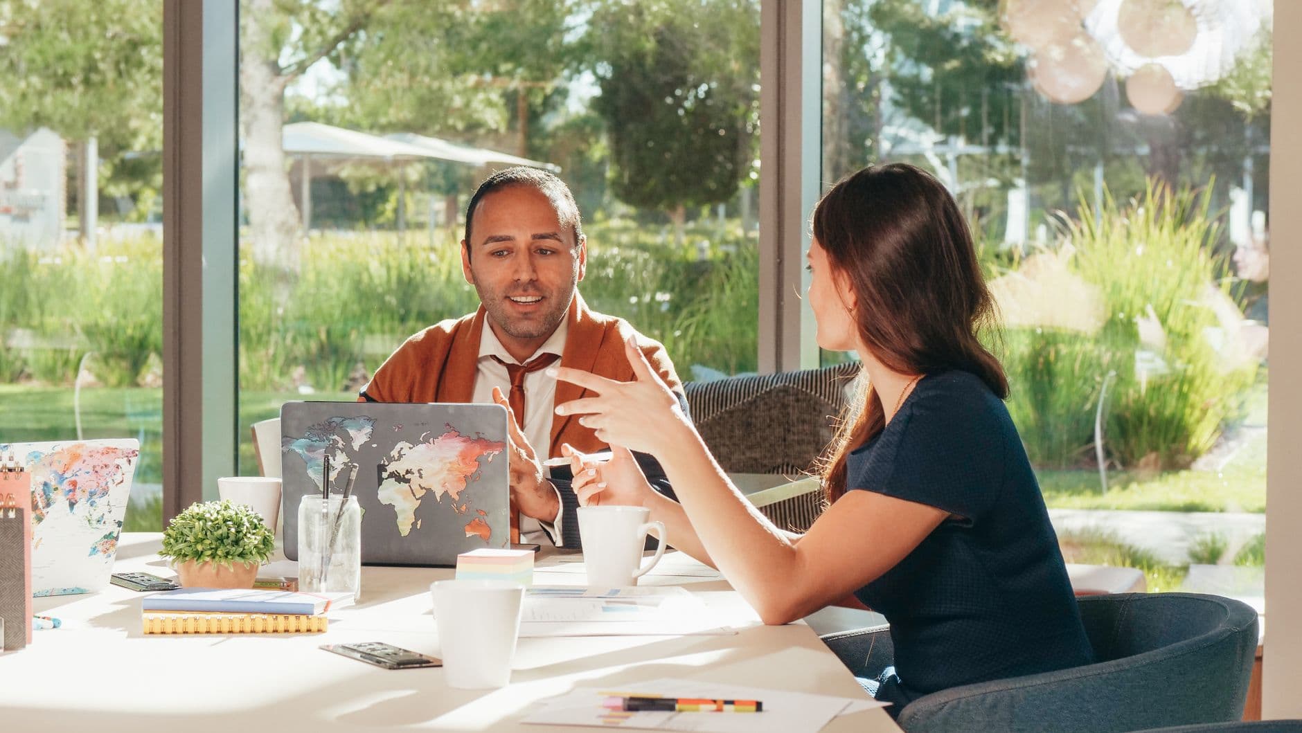 Two business professionals discussing strategy together over a laptop