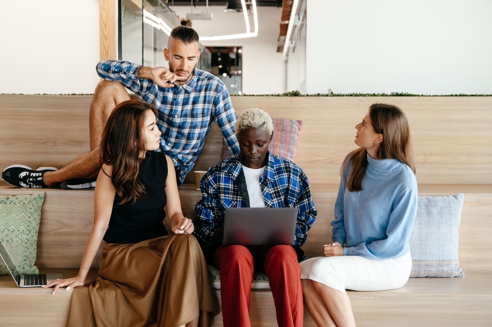 Multiethnic business colleagues talking and collaborating in an office