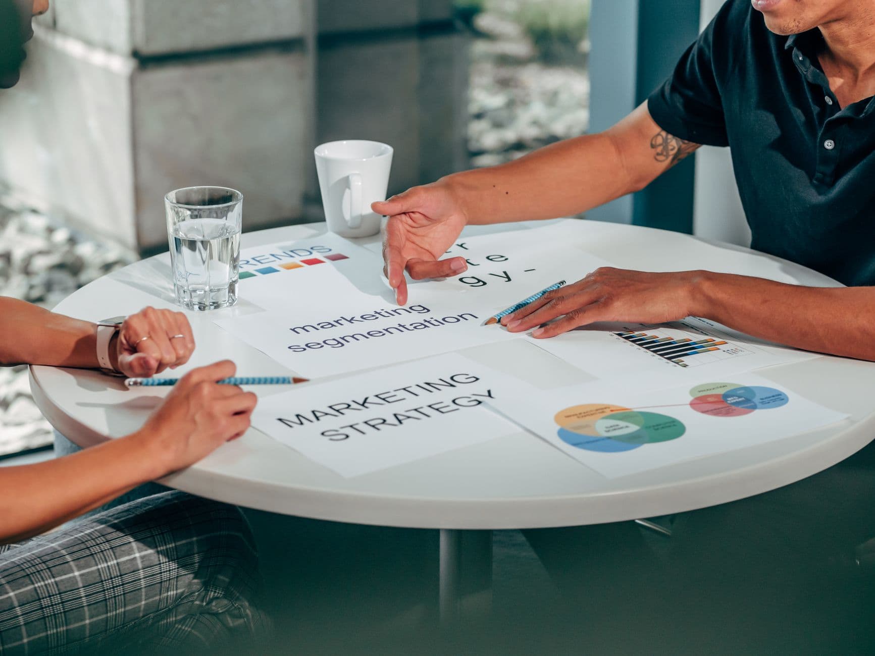 Two professionals in an office discussing marketing strategy