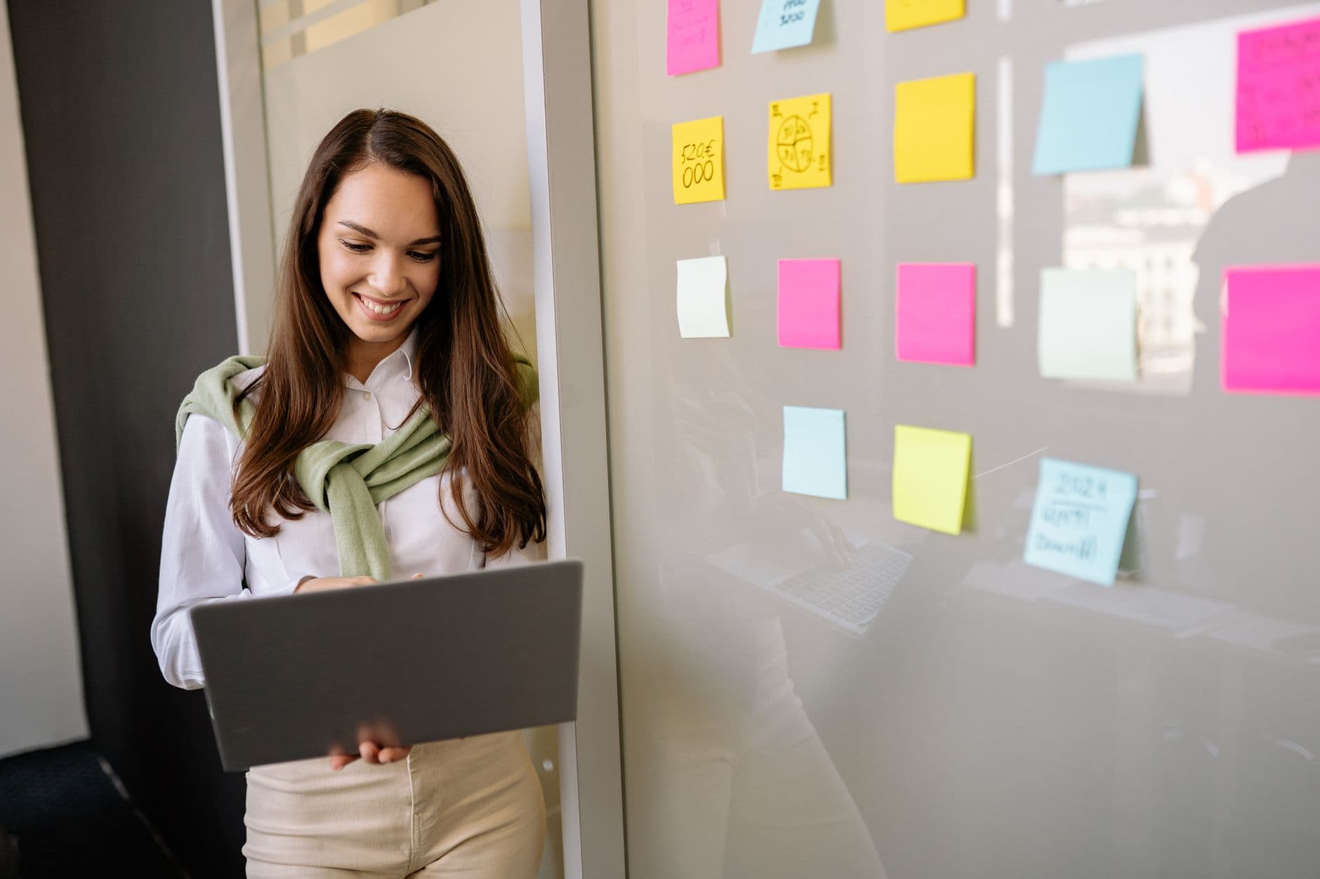 A founder standing in front of a wall of process boards and sticky notes, studying a tangle of operational workflows