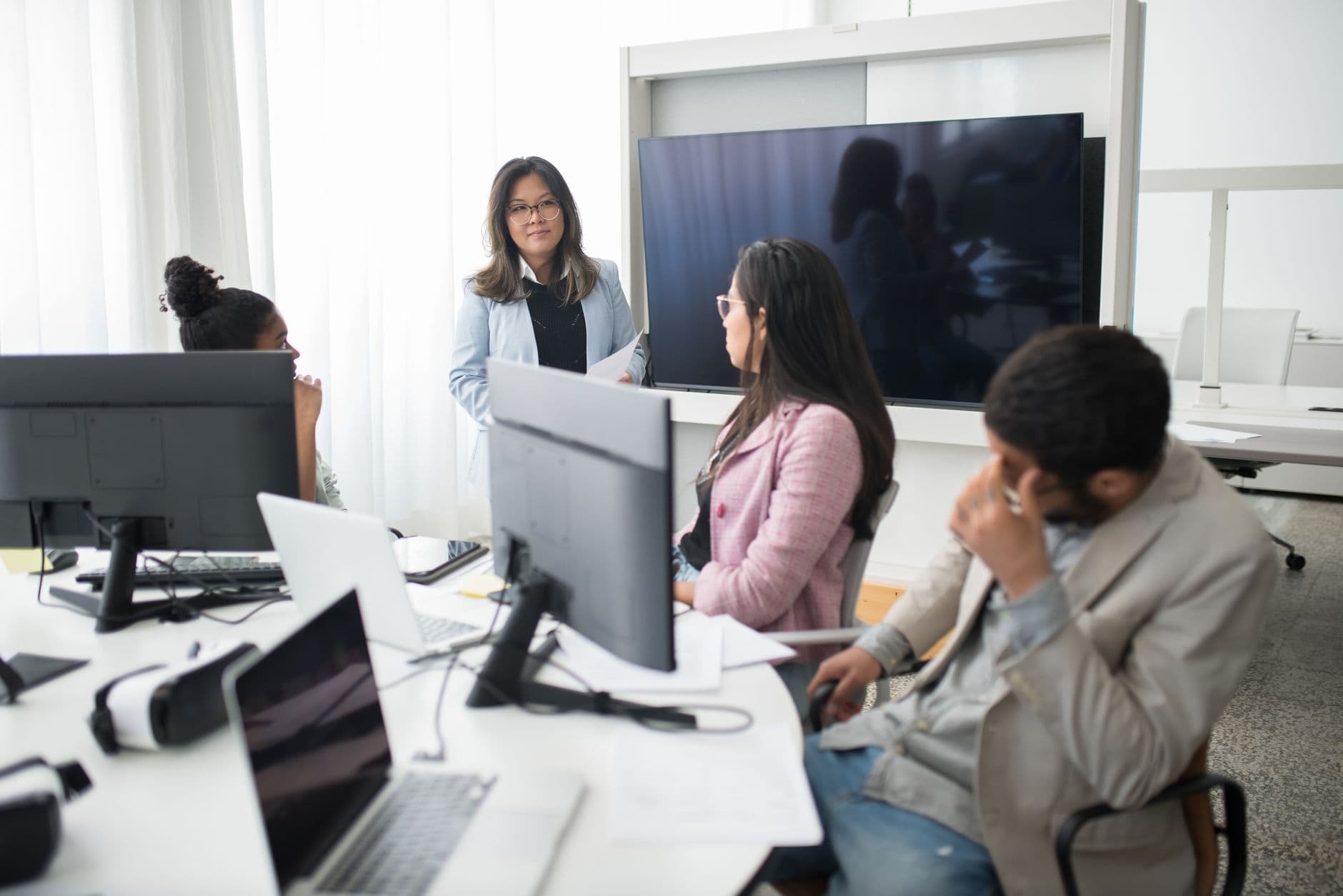A professional team collaborating around a table in a bright modern office